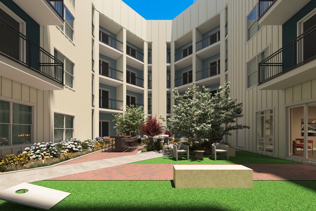 a rendering of a courtyard in a building with green grass and trees at Tiffany Flats, Columbus