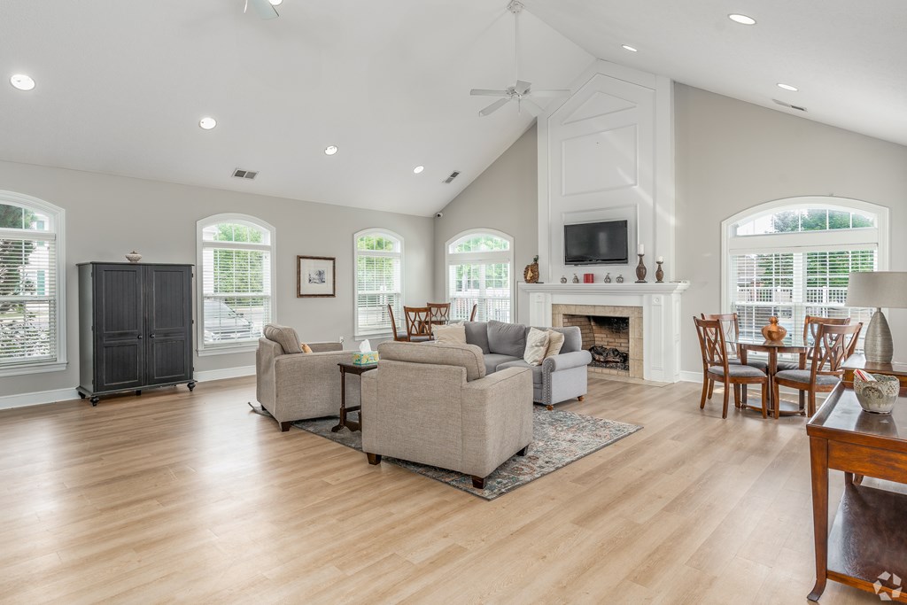 A living room with a fireplace and a television.