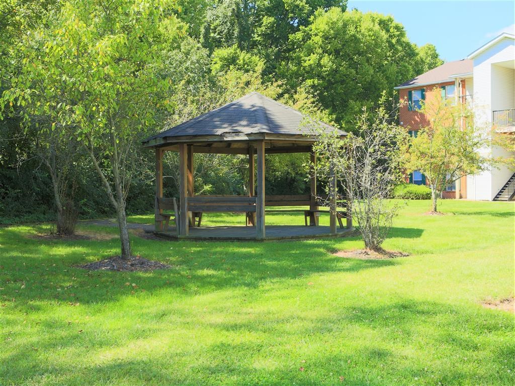 a gazebo in the yard of a house