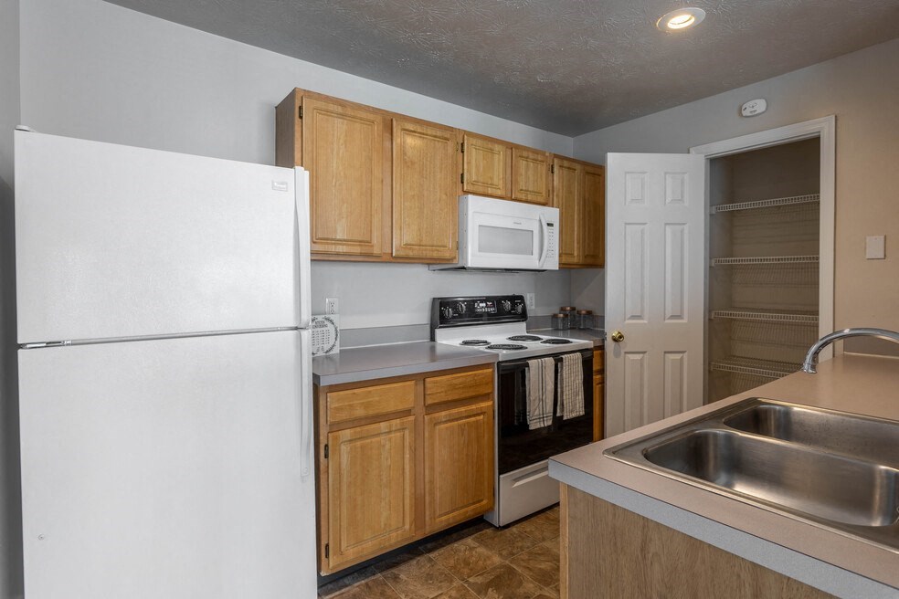 a kitchen with a sink and a refrigerator