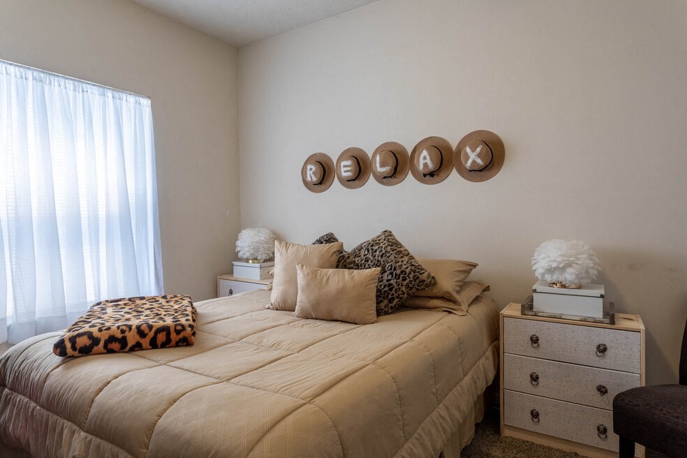 a bedroom with a bed and several pillows on it