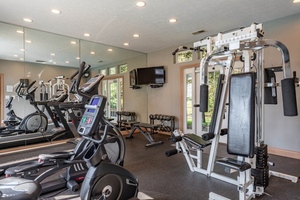 the gym has plenty of equipment and a tv