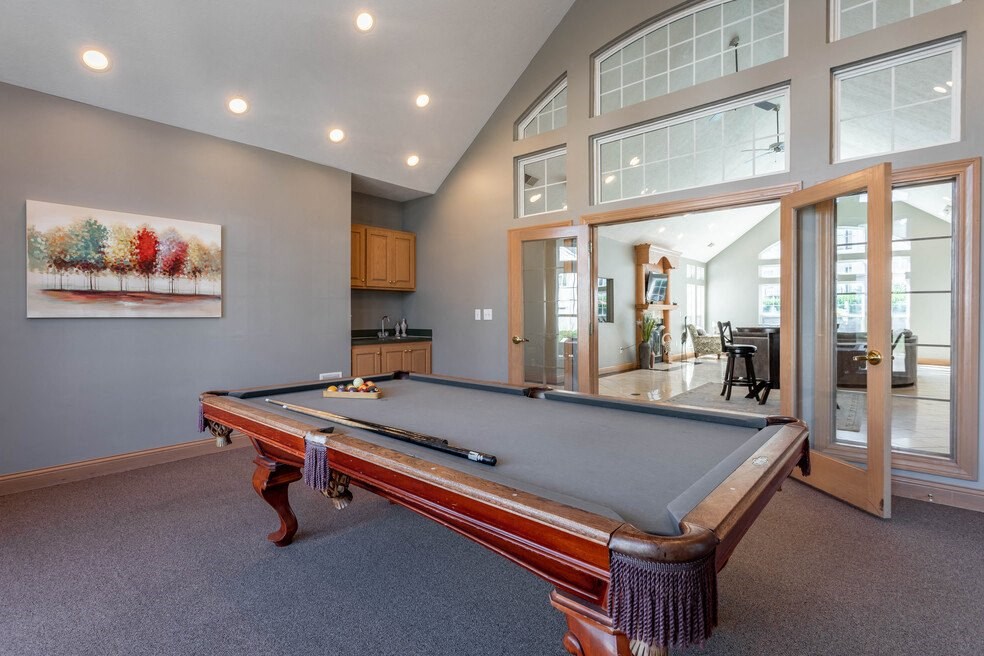 a pool table in a house with windows