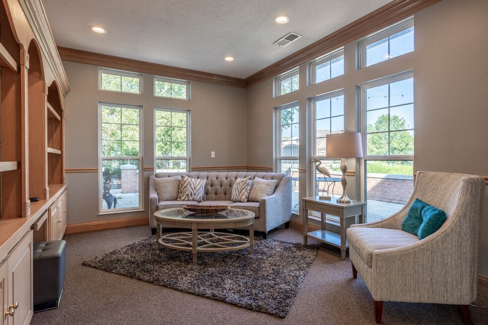 a living room with couches and chairs and a table