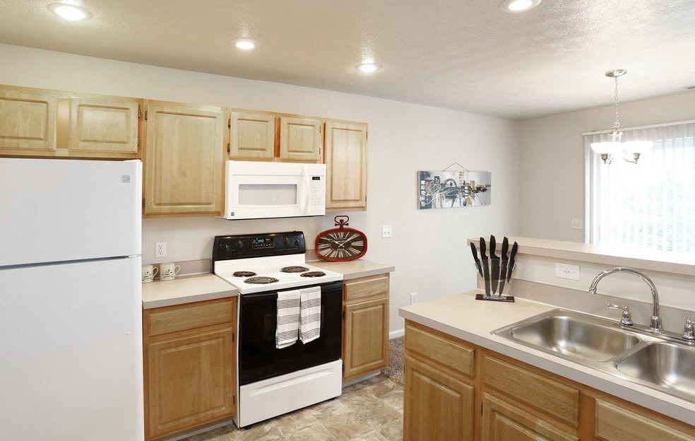 a kitchen with a stove microwave and sink