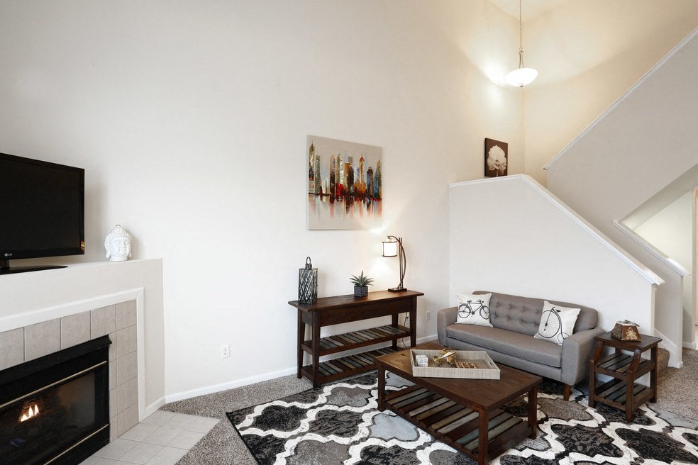 a living room with a couch and a fireplace