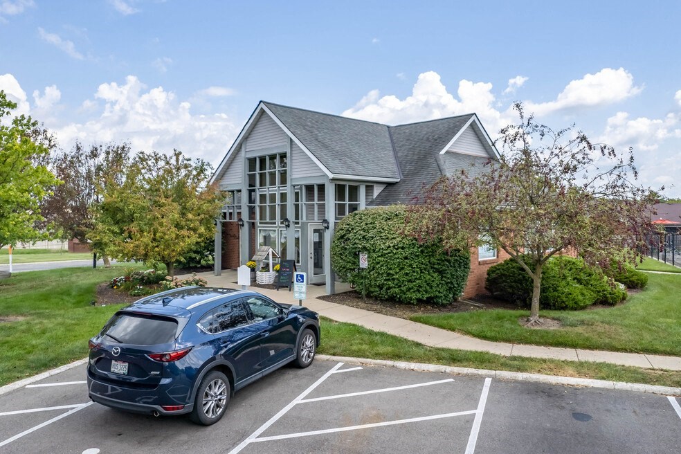 a car parked in a parking lot in front of a house