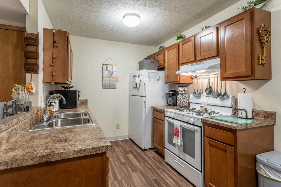 a kitchen with white appliances and granite counter tops