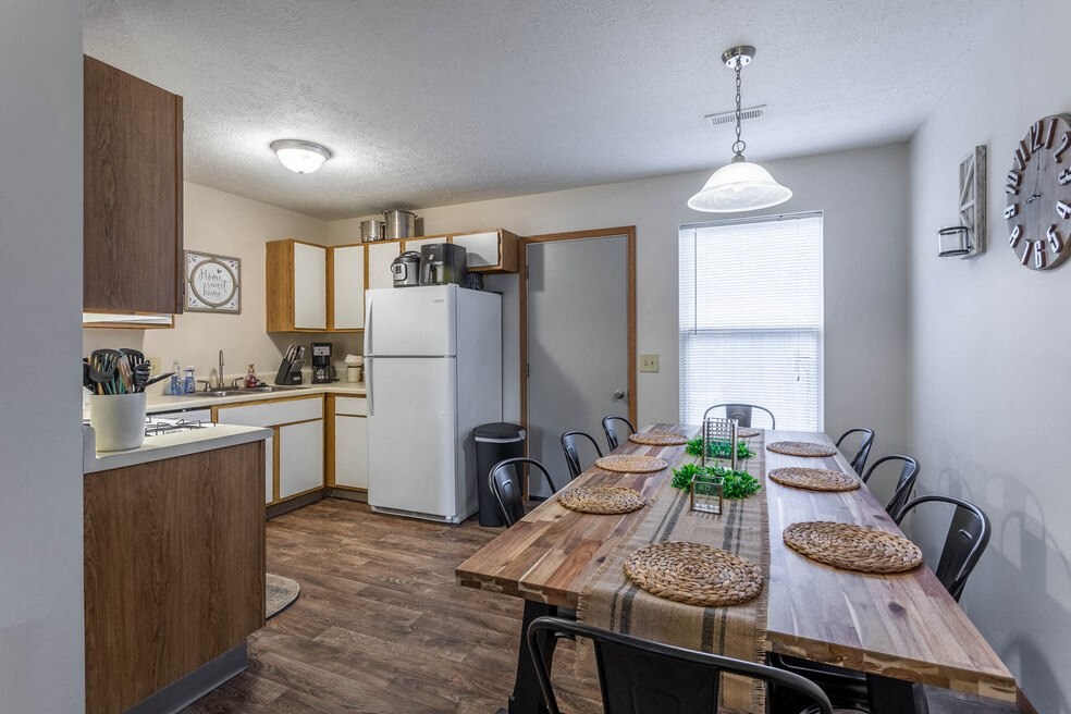 a kitchen and dining room with a wooden table and chairs
