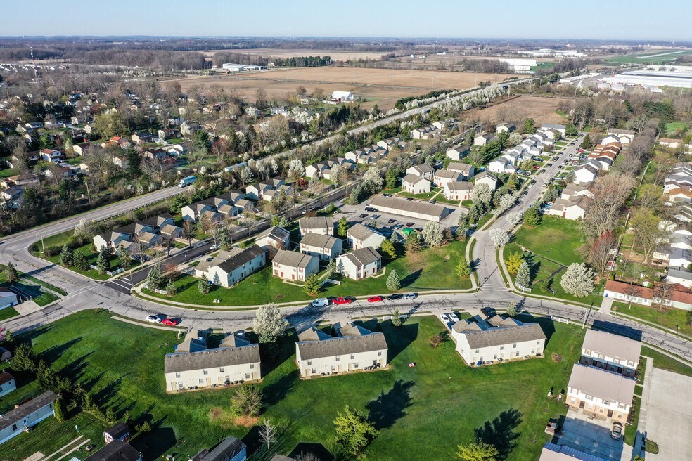 an aerial view of a neighborhood with cars on the road