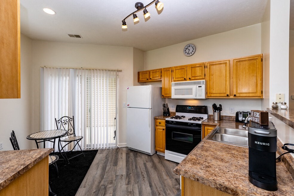 a kitchen with wooden cabinets and a white refrigerator