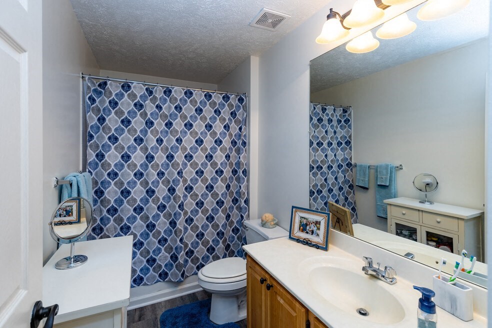 a bathroom with a sink toilet and a shower