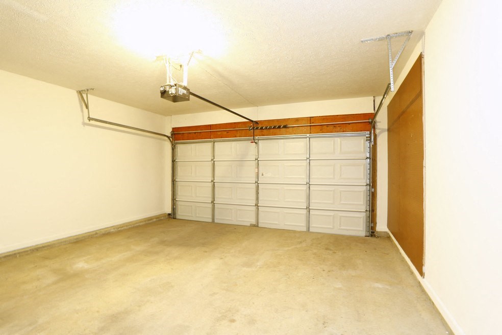 a room with a garage door and a wall of closets