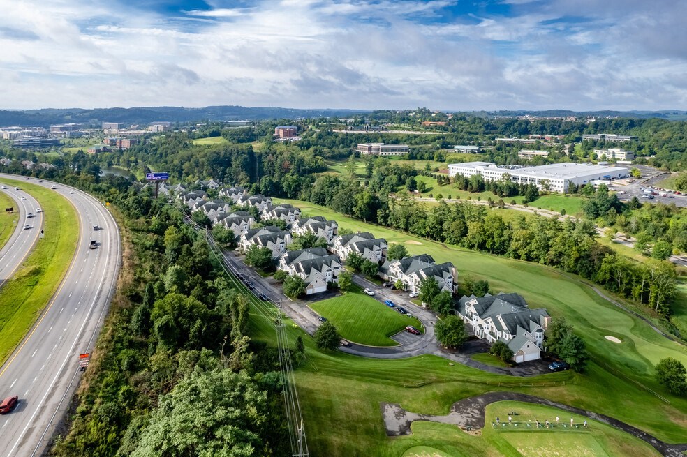 an aerial view of a neighborhood with highways and trees