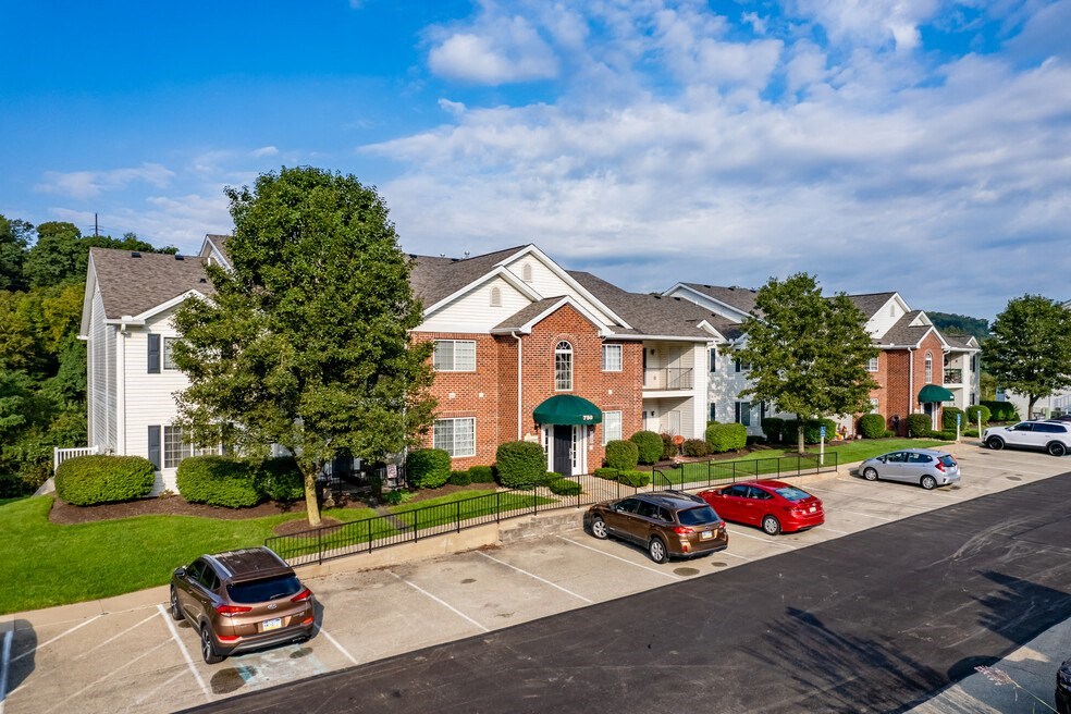 a row of houses with cars parked in a parking lot