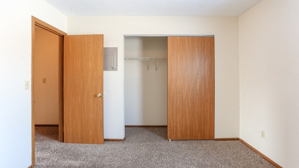 a empty room with a closet and a door