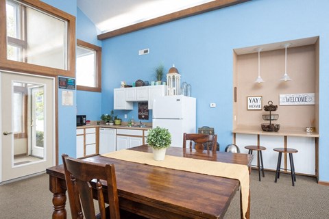 a dining room and kitchen with a table and chairs