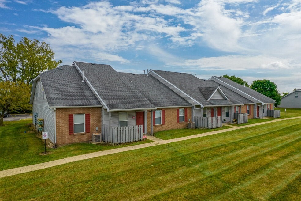 a house with red doors and a green lawn