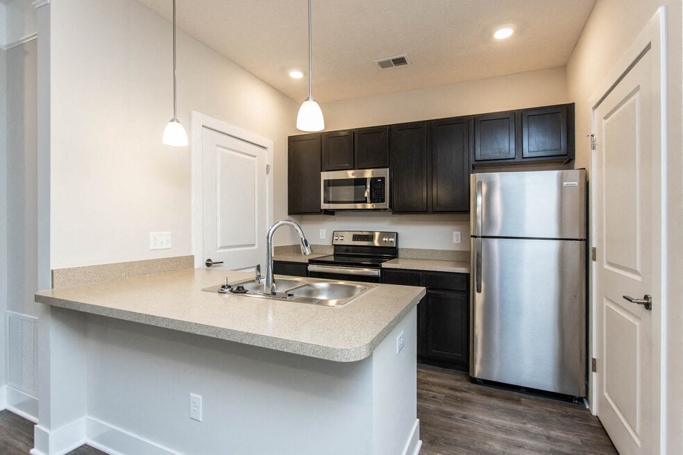 a kitchen with stainless steel appliances and a counter top