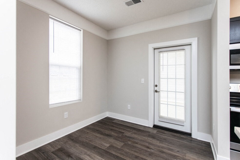 an empty room with a door and a window