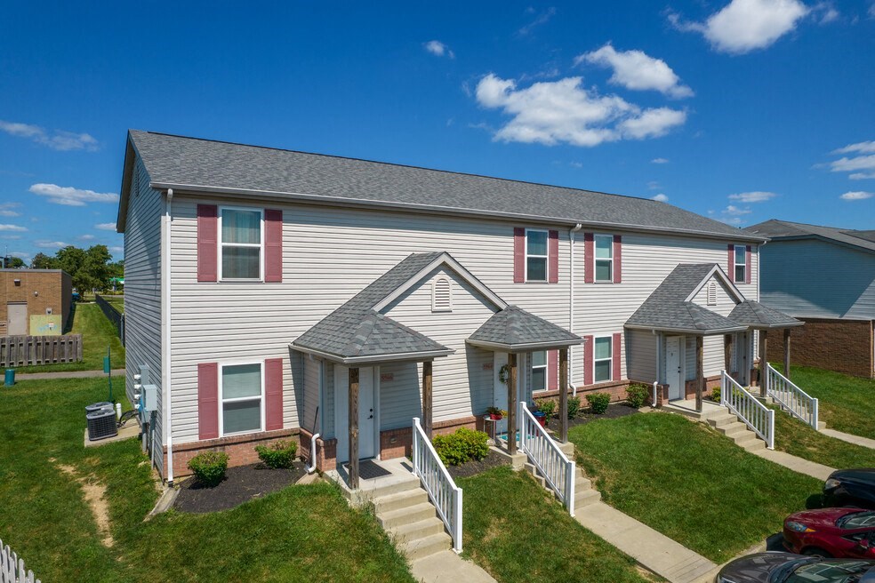 a white house with red shutters and a porch