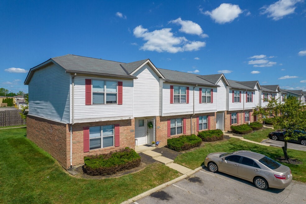 an apartment building with a car parked in front of it