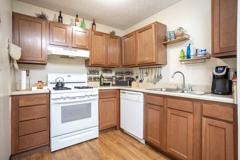 a kitchen with white appliances and wooden cabinets