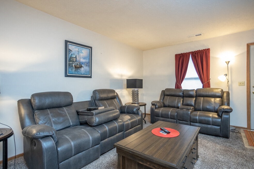a living room with leather couches and a coffee table