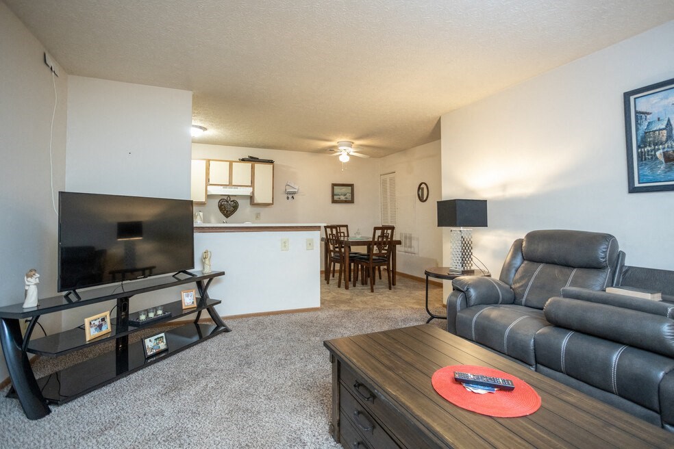 an open living room with a couch and a tv