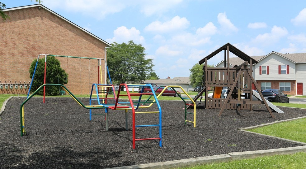 a playground is shown in front of a building