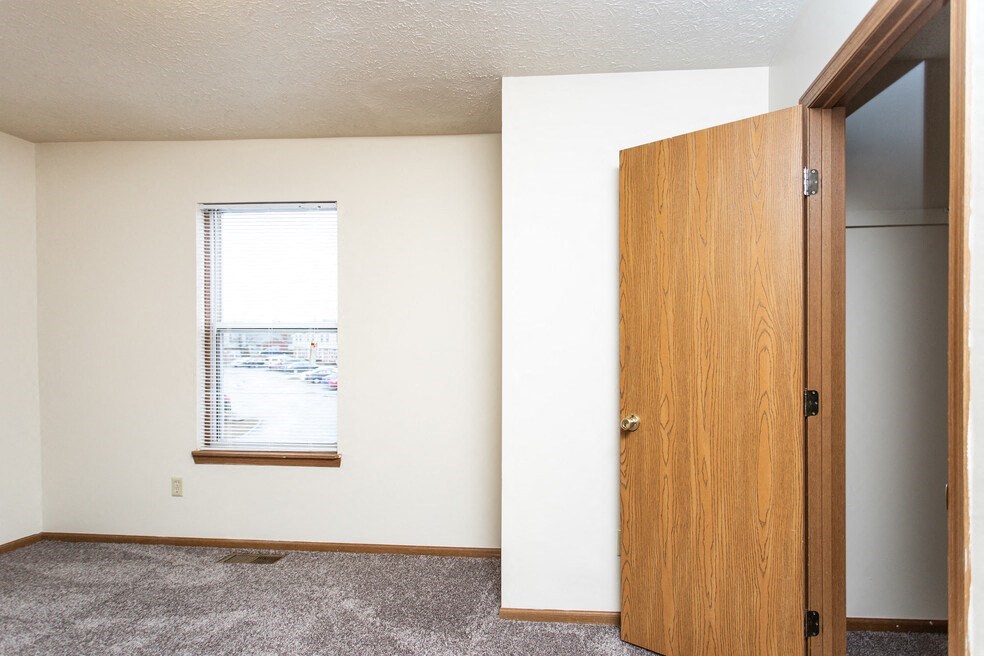 an empty room with a door and a window