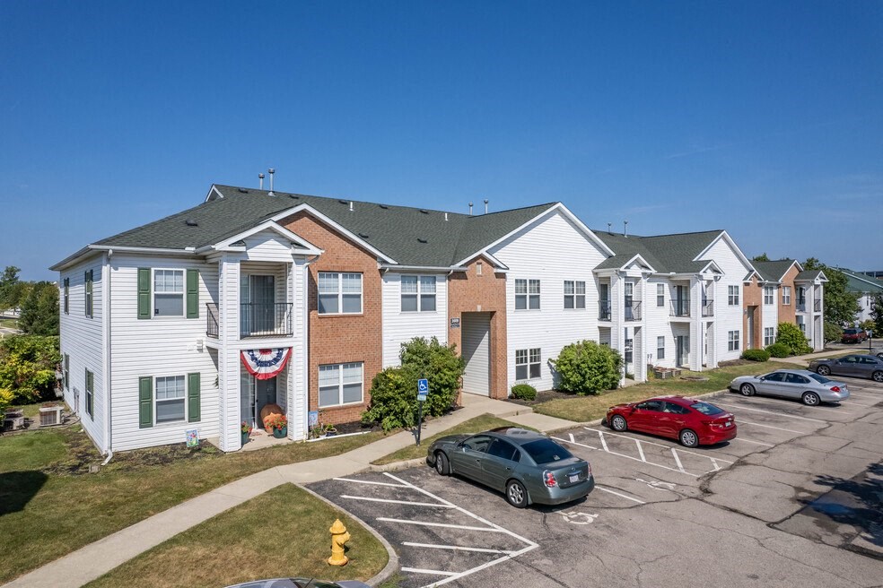 a row of houses with cars parked in front of them