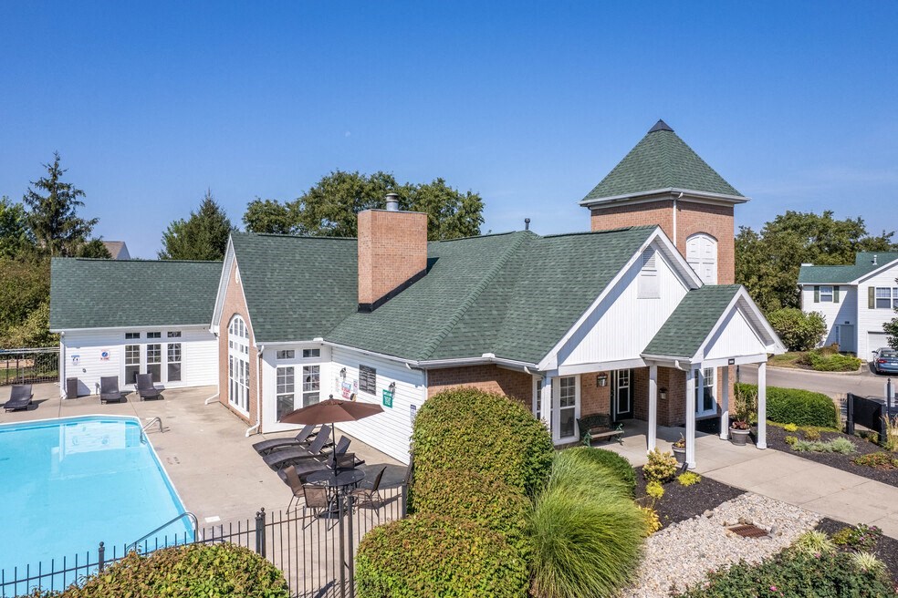 a view of a house with a pool and a building