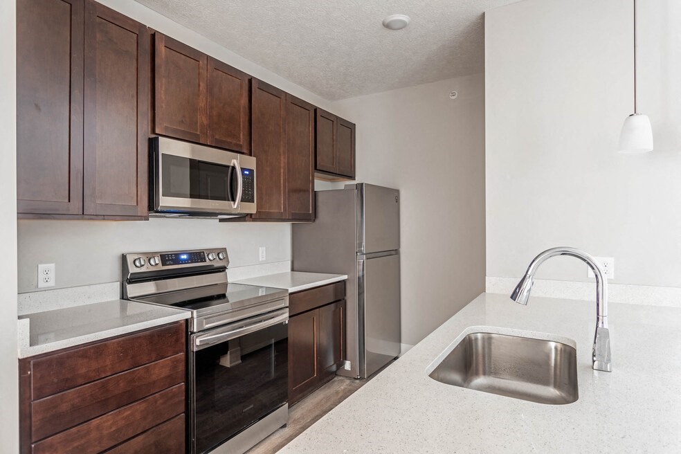 a kitchen with stainless steel appliances and wooden cabinets