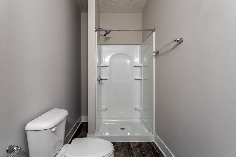 a small bathroom with a shower and a toilet