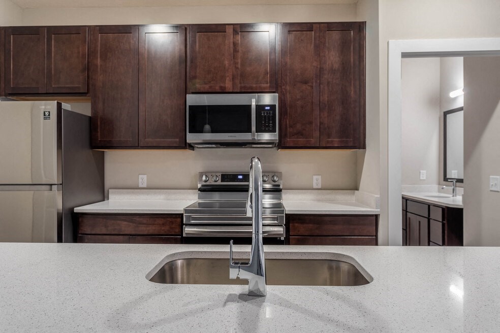 a kitchen with a sink and a microwave