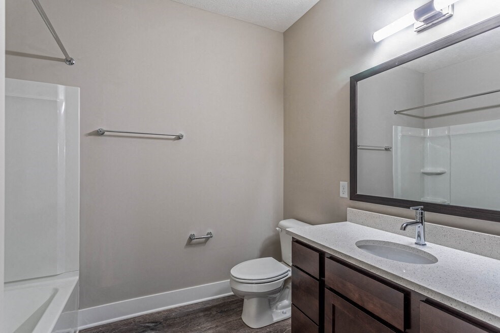 a bathroom with a mirror and a sink and a toilet