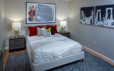 a bedroom with a bed and paintings on the wall