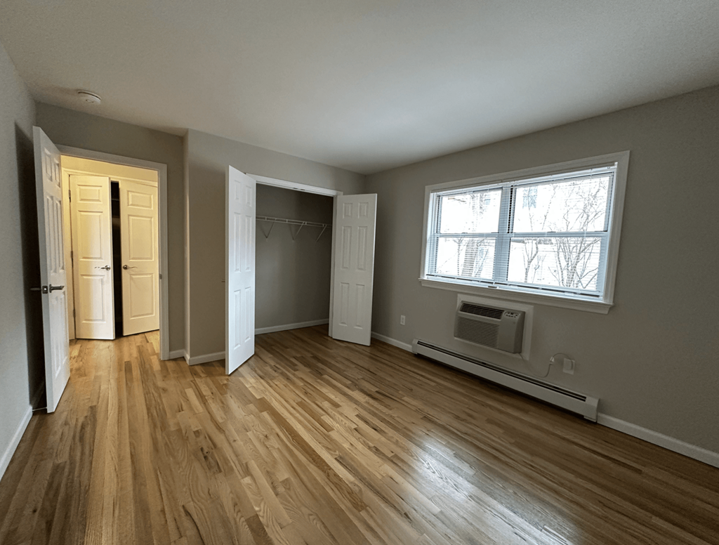 A room with wooden floors and a window.