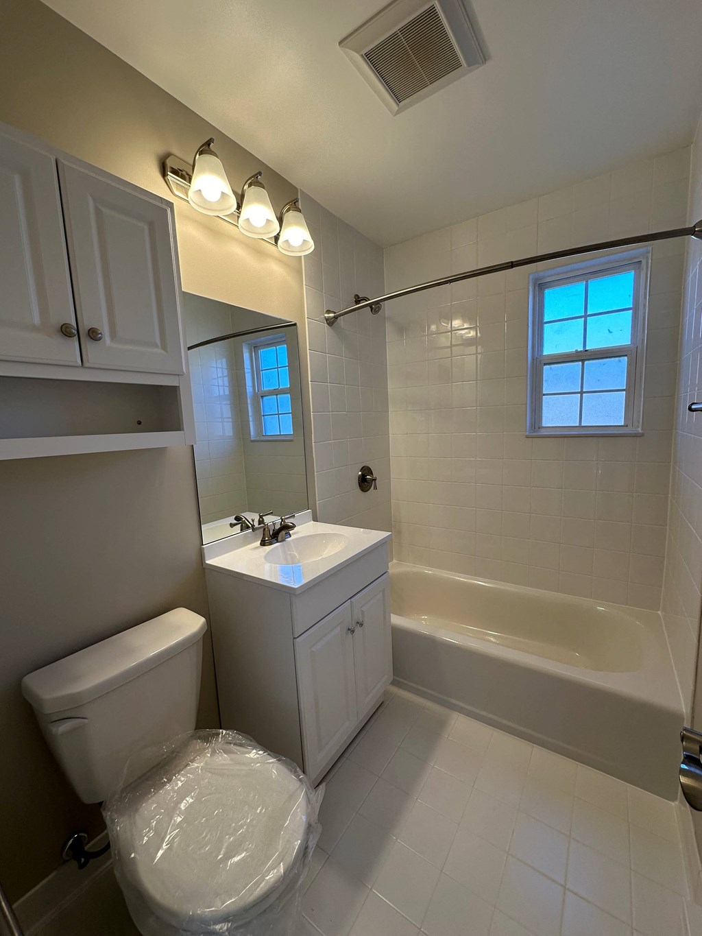 a bathroom with a toilet and a sink and a bath tub