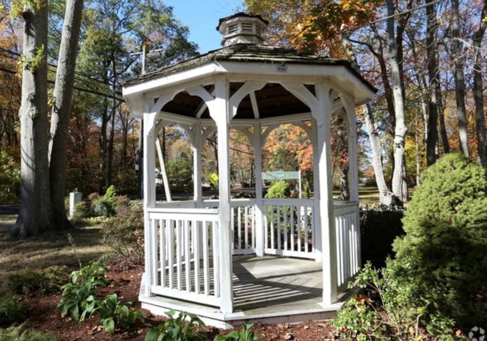 a gazebo in the middle of a garden