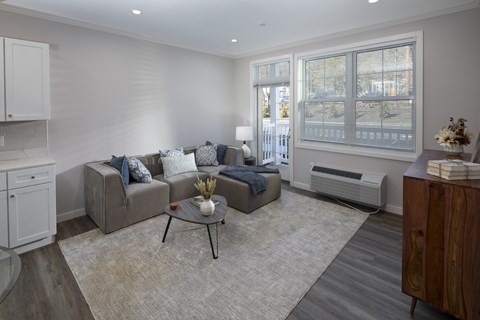 A living room with a grey couch and a coffee table.