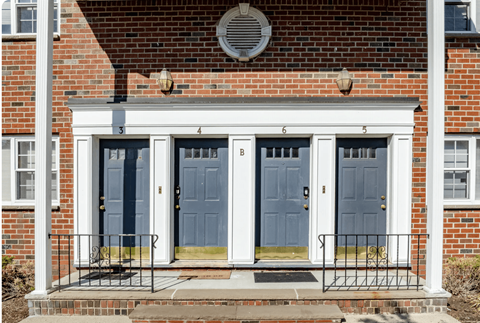 A red brick house with a blue front door.