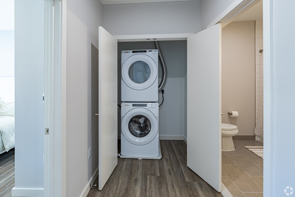 A washing machine is in a small laundry room.