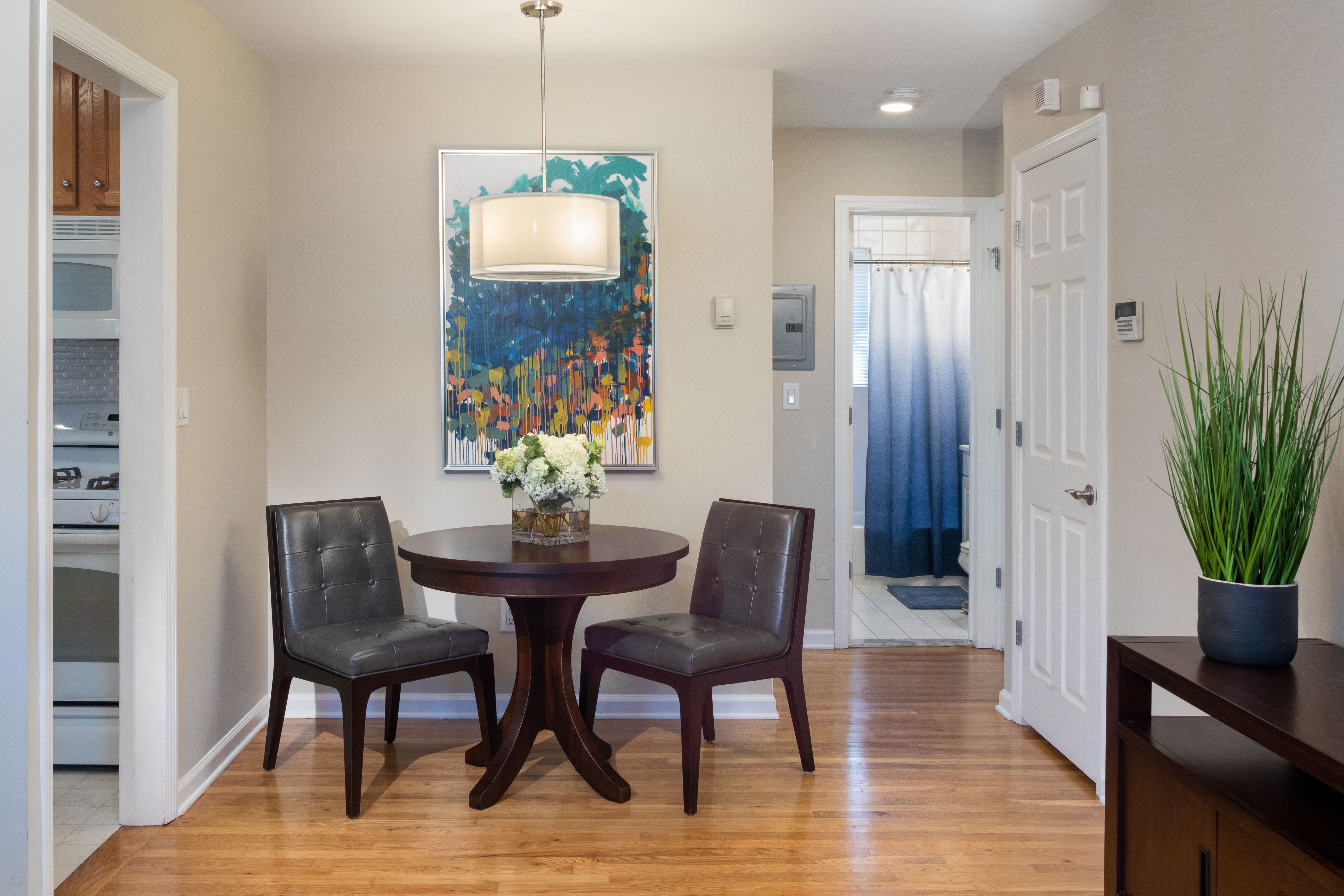 A dining room with a table and chairs.