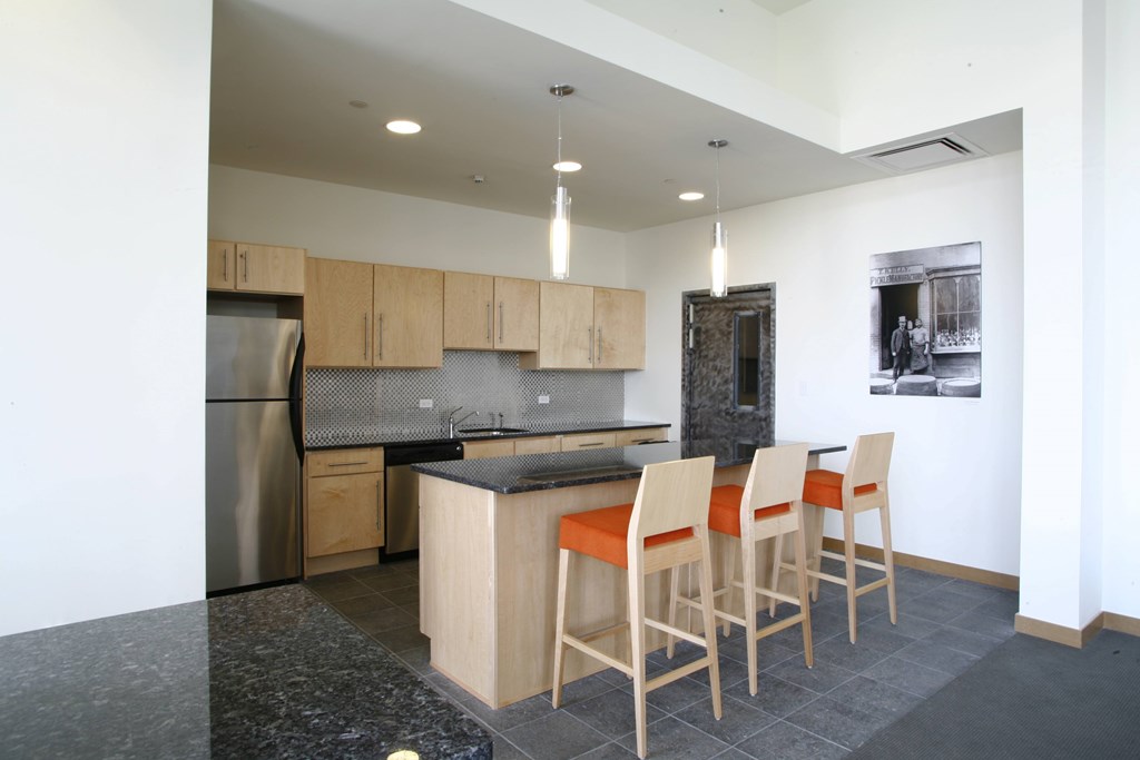A kitchen with a black granite countertop and wooden chairs. A kitchen with a black granite countertop and wooden chairs.at 66 Main, Yonkers New York