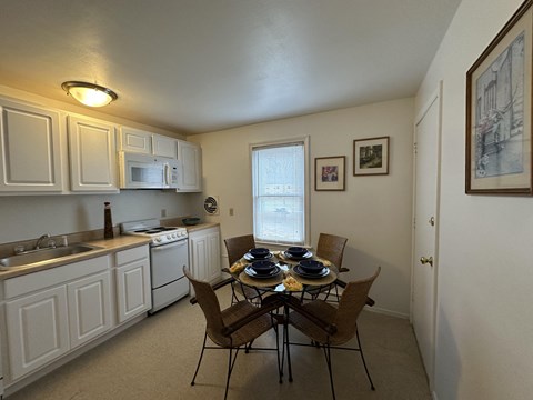a kitchen and dining room with a table and chairs