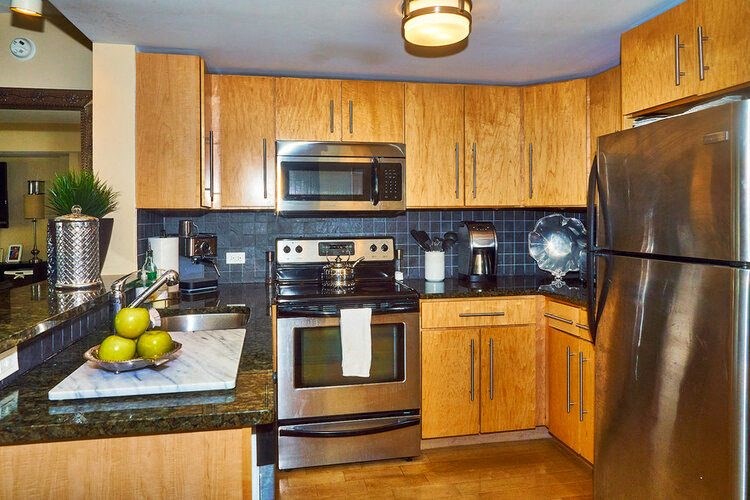 66 Main - Kitchen w/ Granite Counter and Backsplash