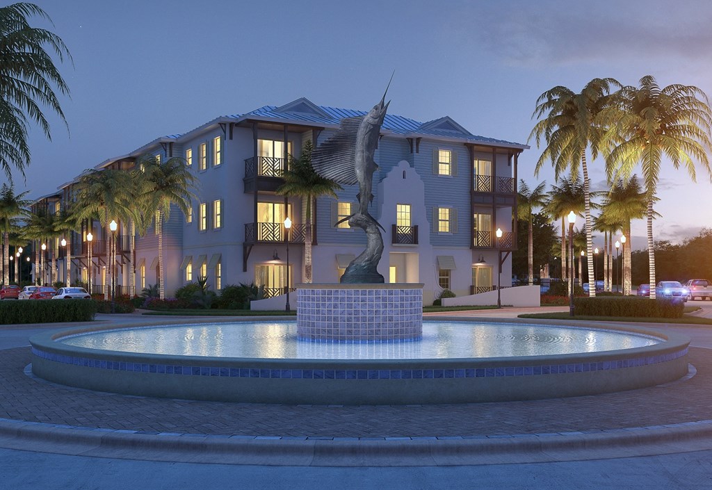 A large house with a fountain in front of it.
