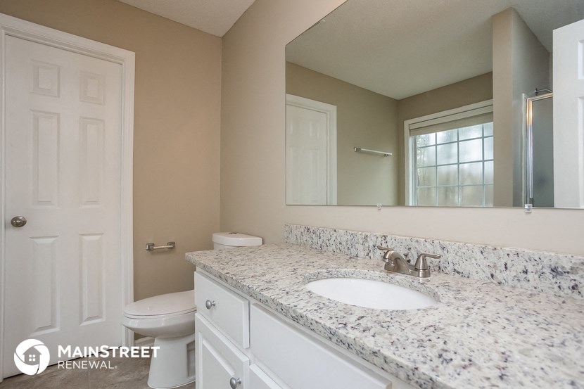 a bathroom with a sink and a mirror and a toilet